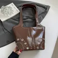 Retro dark brown glossy shoulder bag with silver rivet details and wide handle design - Brown