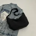 Minimalist black high-density nylon crossbody bag with adjustable wide strap for daily use - Black