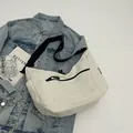 White nylon crossbody chest bag with black zipper pockets and wide shoulder strap - Off-white