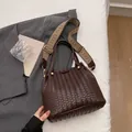 Dark brown woven tote bag with gold ball hardware and geometric pattern strap - Coffee