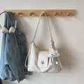 Creamy white chic shoulder bag with silver star emblem and plush cloud charm - Off-white
