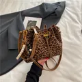 Elegant leopard print drawstring bucket bag with brown strap and wooden bead charm - Leopard Print With Pendant