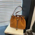 Brown suede drawstring bucket bag with gold chain strap and metal ball charms - Brown No Pendant