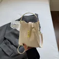 Vintage cream woven bucket bag with gold metal lock and detachable shoulder strap - Off-white