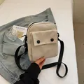 Minimalist cream canvas crossbody bag with front flap pocket and adjustable strap - Off-white