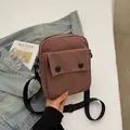 Minimalist canvas shoulder bag in dusty rose with black buttons and adjustable strap - Pink