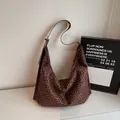 Large leopard print hobo bag with adjustable strap on a marble surface - Coffee