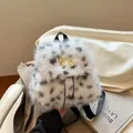 Zaino di peluche a pois bianchi e neri con decorazione a fiocco in metallo dorato - Bianco