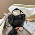 Minimalist black leather bucket bag with gold bead drawstring and crossbody strap - PU Black