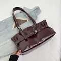 Minimalist burgundy high-gloss leather shoulder tote bag with silver buckle strap accents - Burgundy