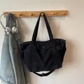 Large black denim tote bag with adjustable shoulder strap and metal snap button pocket - Black Large