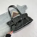 Retro black glossy leather shoulder bag with metallic buckle and eyelet details - Black