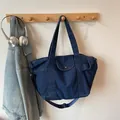 Dark blue denim tote bag with adjustable shoulder strap and snap pocket detail - Dark Blue Large