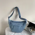 Quilted gray-blue crossbody bag with adjustable strap and multiple zip pockets - Light Blue