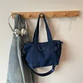 Deep blue denim tote bag with adjustable strap and front pocket in workwear style - Dark Blue Small