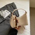 Chic beige underarm bag with wooden bead tassel and textured PU leather finish - Off White