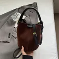 Brown suede and black leather bucket bag with top handle and adjustable strap - Coffee