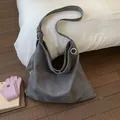 Detail of grey leopard print tote bag with wide shoulder strap and metal ring hardware - Gray