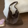 Detailed view of brown leopard print tote bag with soft suede texture and metallic eyelets - Brown