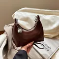 Dark brown faux leather crescent bag with silver metallic ball and slim shoulder strap - Brown