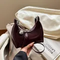Minimalist burgundy hobo bag with glossy finish and silver sphere charm detail - Burgundy