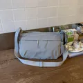 Detail of light gray nylon crossbody bag with dual zipper pockets and wide strap - Gray
