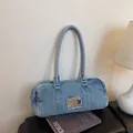 Light blue washed denim boston bag with raw edges and vintage metal plate detail - Light Blue