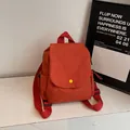 Mini orange canvas backpack with yellow button flap and adjustable straps - Orange