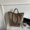 Brown checkered nylon tote bag with rope handles and red woven label detail - Khaki