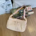 Beige nylon crossbody bag with dual zipper pockets and adjustable wide shoulder strap - Pink
