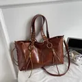 Vintage brown oil-wax leather tote bag with fringe, zippers and woven handle details - Brown