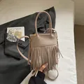 Vintage beige tassel bucket bag with suede texture and adjustable shoulder strap - Khaki