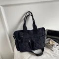 Black quilted large capacity tote bag with crossbody strap and front zipper pockets - Black