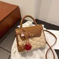 Brown leather and beige plush crossbody bag with golden clasp and fur ball charm - Brown with Pendant