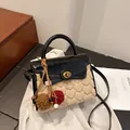 Elegant black and beige contrast handbag with heart texture and decorative charm - Black With Pendant