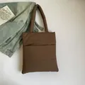 Large dark brown quilted nylon tote bag with padded handles and soft puffer texture - Brown