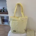 Quilted padded tote bag in light yellow with shoulder straps and front pocket - No Pendant / Yellow