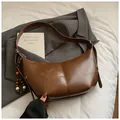 Vintage brown crescent shoulder bag in sleek faux leather with decorative bead charm - With Pendant / Brown