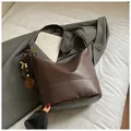 Deep brown oversized hobo bag with contrast stitching and decorative bead charm - With Pendant / Brown
