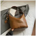 Coffee brown faux leather bucket bag with white contrast stitching and wooden bead charm - With Pendant / Brown