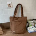 Brown quilted puffer tote bag featuring two front pockets and long shoulder straps - No Pendant / Brown