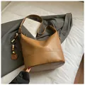 Brown minimalist shoulder bucket bag with decorative wooden beads and adjustable strap - With Pendant / Khaki