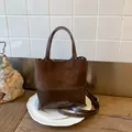 Dark brown leather bucket bag in vintage style with contrasting matte and glossy textures - Coffee without Pendant