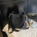 Black woven bucket bag with stylish contrast wide strap and gold hardware accents - Black Plaid