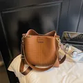Brown woven bucket bag with matching inner pouch and adjustable shoulder strap - Brown Grid