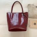 Burgundy faux leather large tote bag with glossy finish and woven rope tassel detail - Red with Pendant