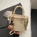 Cream white leather hobo bag with plush fur trim and cute cookie pendant accessory - Off-white With Pendant