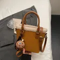 Yellow leather bucket bag with cream faux fur trim and cute plush cookie charm - Brown with Pendant