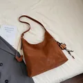 Brown large capacity hobo tote bag in matte suede with clover charm and adjustable strap - With Charm / Brown