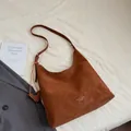 Brown leather large tote bag with horse pendant in a stylish flat lay fashion setting - No Pendant / Brown
